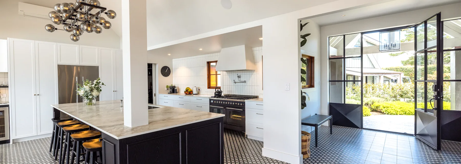 A wide-angle photo of the kitchen bench with views towards the front door