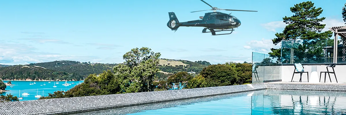 A photo of a helicopter flying past the pool, coming in to land