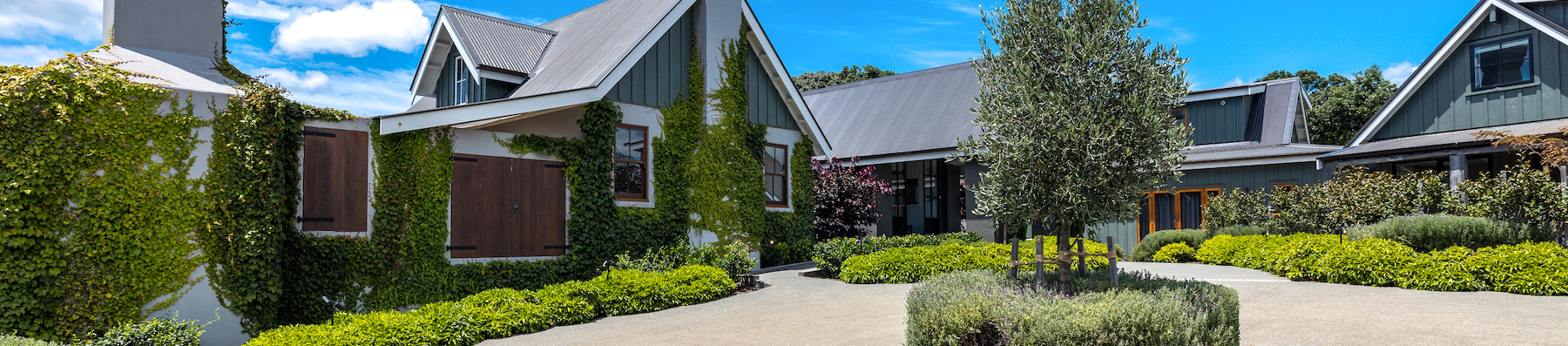 Wide angle photo of the entrance to the property, taken from the driveway