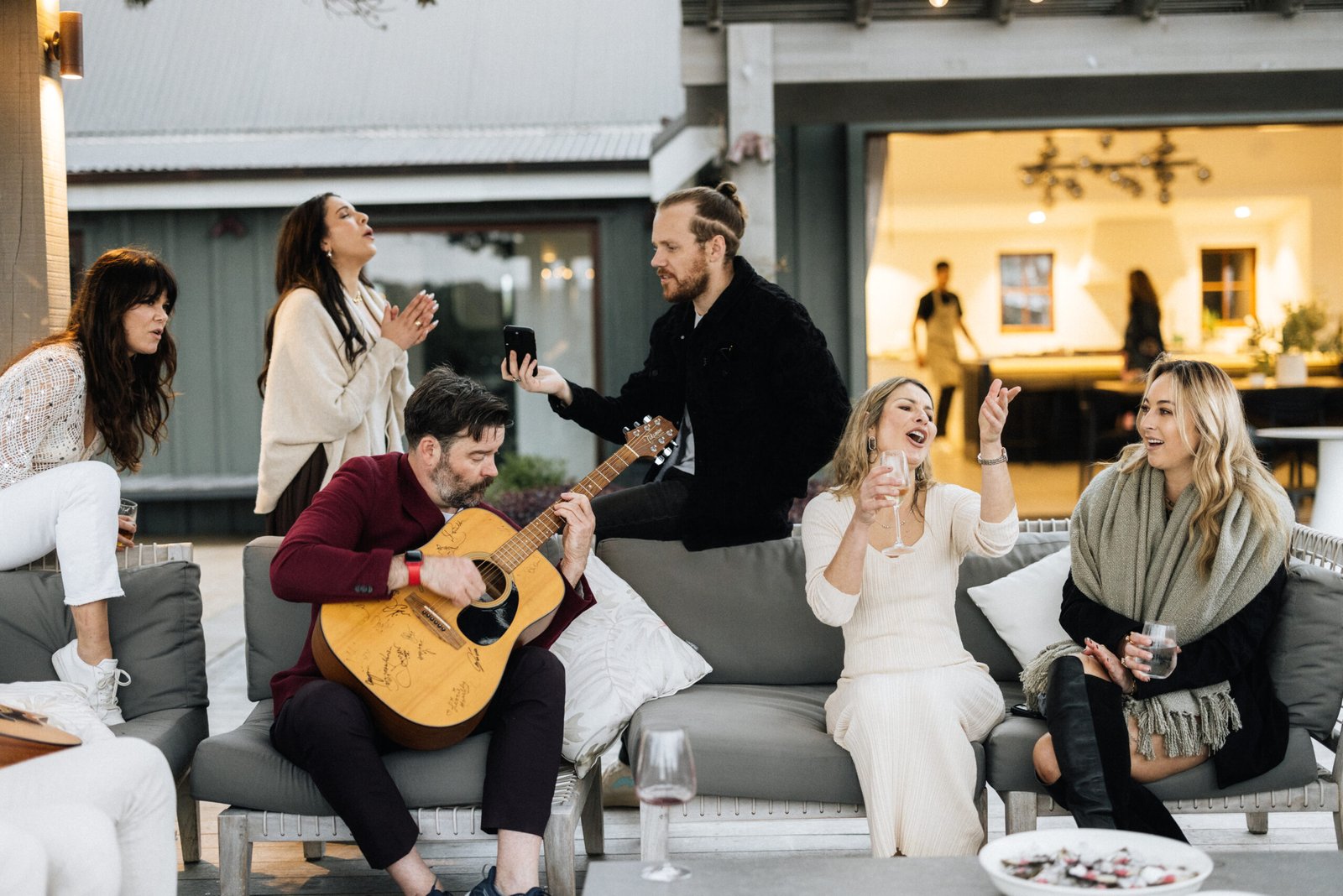 Guests celebrating outdoors at Putiki Estate, a luxury accommodation on Waiheke Island
