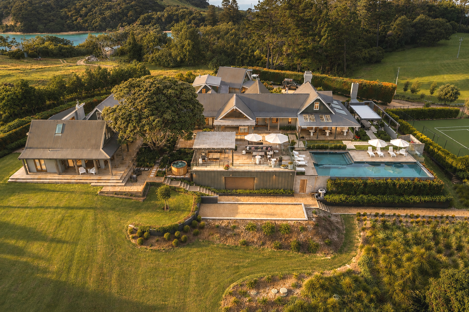 A bird’s-eye view of Putiki Estate, a private luxury lodge on Waiheke Island, surrounded by the Hauraki Gulf.