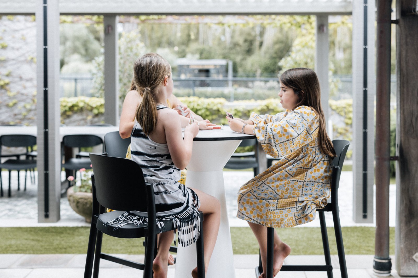 Children playing cards at Putiki Estate, family-friendly luxury accommodation on Waiheke Island