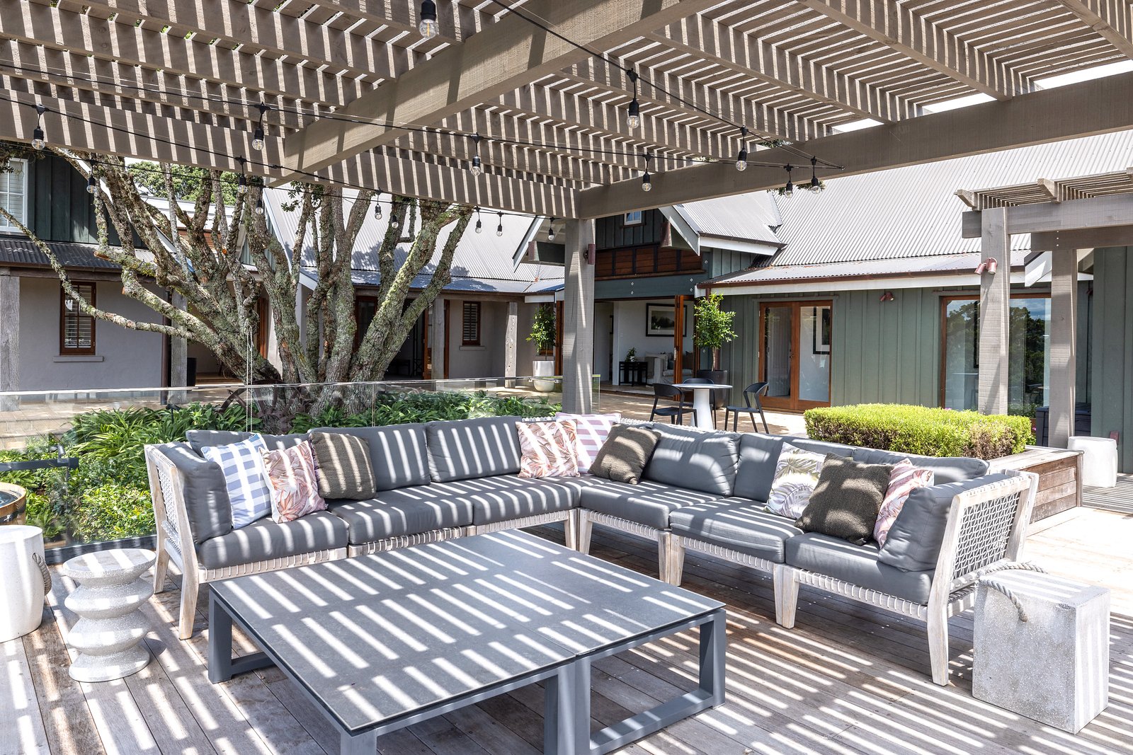 Guests dining on the veranda at Putiki Estate, luxury accommodation on Waiheke Island